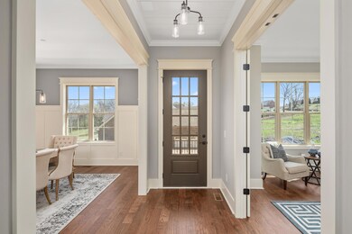 Solid hardwood front entry doors have glass insert accents. Crown molding is used through out the main level. These are just a few of the detailed features in this customized home.
