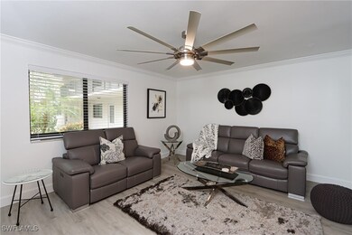 Living room with ornamental molding, wood finished