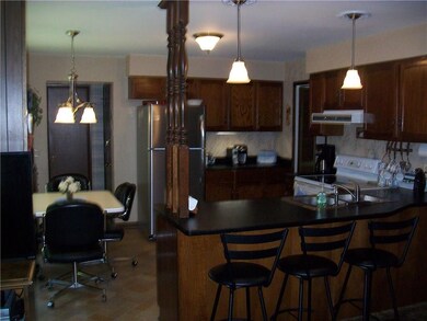 Kitchen with snack bar and breakfast table with ne