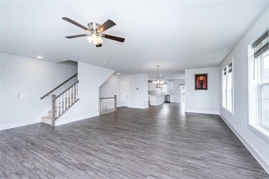  living room with dark wood finished floors, a cha