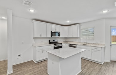 Bright kitchen with an expansive center island perfect for gatherings *Model representation
