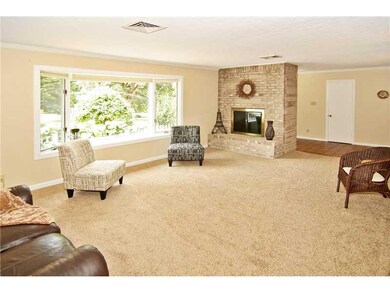 Living Room. Living room  has new carpet, new lighting and a brick Fireplace, BIg picture window opens overlooking your yard & plenty of sunlight