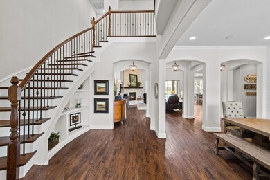 Upon entry through the custom wrought iron door you are greeted with soaring ceilings, beautiful hand-scraped wood floors, and an open concept design.