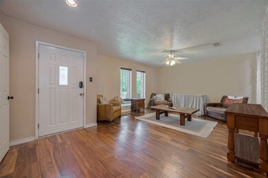 Warm and spacious living area with rich wood floor
