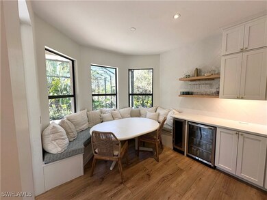 Dining area featuring bar, beverage cooler, and li