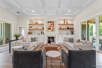 Living room featuring beam ceiling, light wood-typ