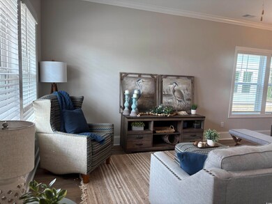 Living room with wood finished floors, baseboards,
