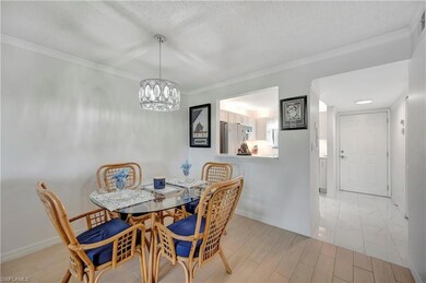 Dining area with crown molding, a textured ceiling
