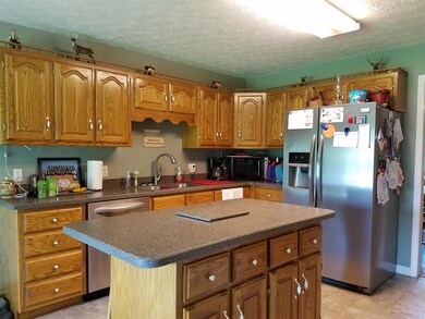 For the Cook in the Family.... shining oak cabinetry that looks new, Corian countertops, and a large center Island.