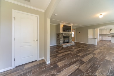 Unfurnished living room featuring dark wood-style