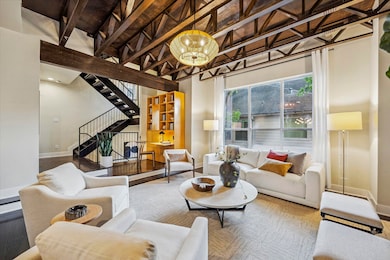 Open-concept living with soaring ceilings and seam