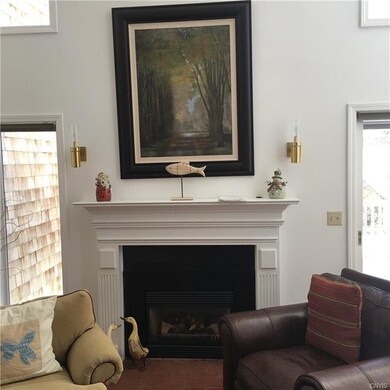Handsome gas fireplace flanked by abundant natural