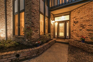 Front entry at dusk welcomes you into this 4000+ square foot custom house