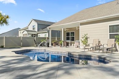 View of pool featuring ceiling fan and a patio