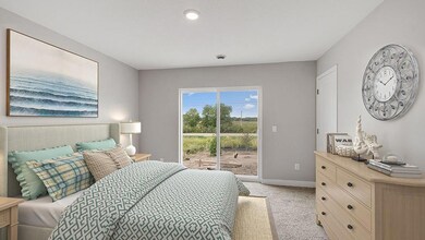 The primary suite opens to a spacious patio! Photo of actual home!