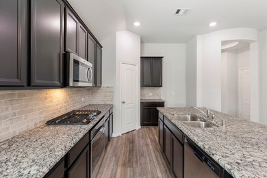 The island kitchen features leather texture finish
