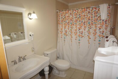 Bathroom featuring tile patterned floors, sink, to