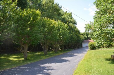 Driveway lined with beautiful crepe myrtle trees.