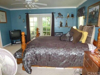Double French doors from the master bedroom to the backyard patio area.