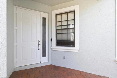 Property entrance featuring stucco siding