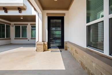 Doorway to property with stucco siding and a patio