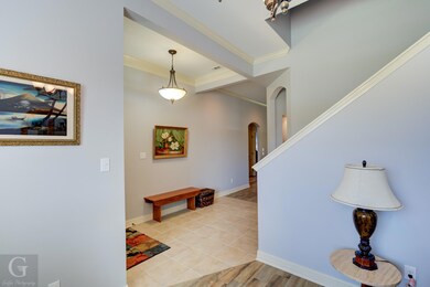 Foyer featuring crown molding and light wood-type 