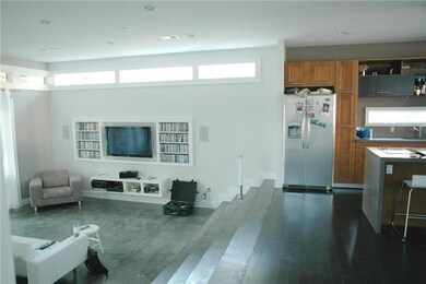 Sunken Living room with concrete finished floors, open floor plan and with sliding doors to the covered patio; Living room is wired for surround sound