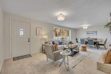 Living room with light colored carpet and a textured ceiling