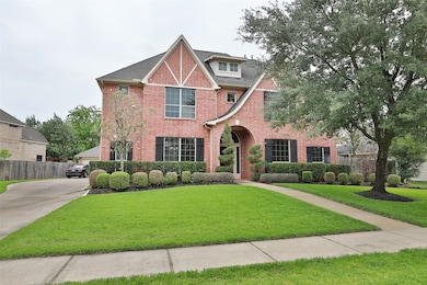 Stunningly landscaped with sprinkler system, this residence welcomes you home with a 3-car garage and elegant front porch with architectural archway into an grand entry.