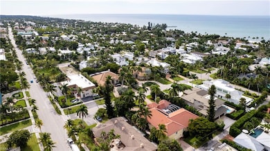Birds eye view of property featuring a water view and a residential view