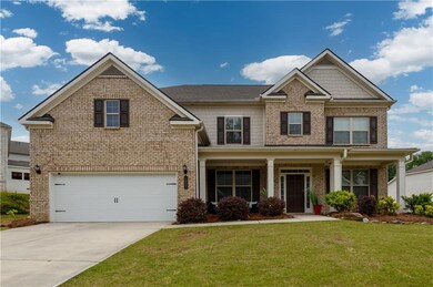 Craftsman-style home featuring brick siding, a gar