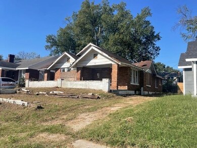 View of side of property featuring a yard