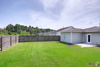 Covered front porch and open patio in backyard.