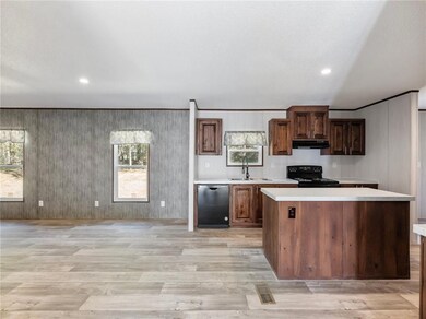 Kitchen featuring light countertops, dishwasher, b