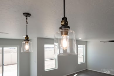 Detailed view of wood finished floors and a textured ceiling