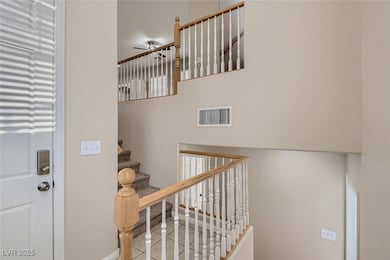 Staircase with ceiling fan and tile patterned floo