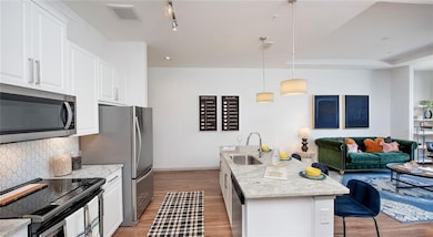 Kitchen featuring light wood-type flooring, pendan