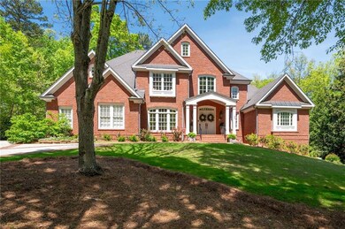 Nestled on a lush, private lot, this grand brick e
