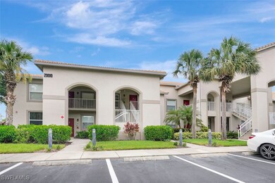 View of property with uncovered guest parking