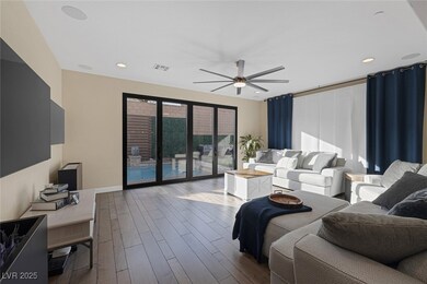 Living area featuring a ceiling fan, dark wood-sty