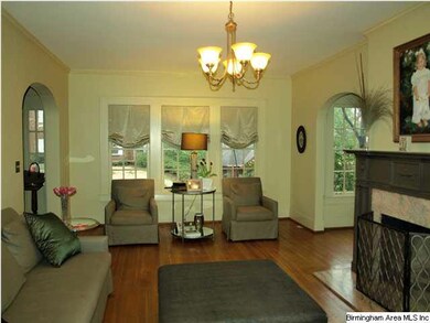 Sunny living room with graceful archeways opening 