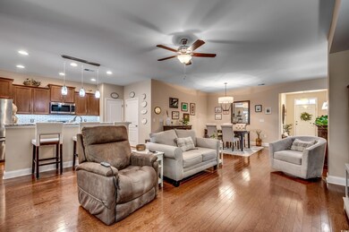 Great room with wood flooring and ceiling fan