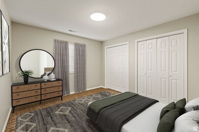 Carpeted bedroom and two closets, digitally staged for inspiration