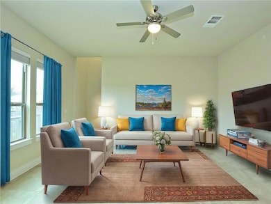 Living room with a ceiling fan and visible vents