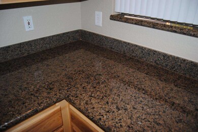 Slab Granite in Kitchen and Bathrooms!