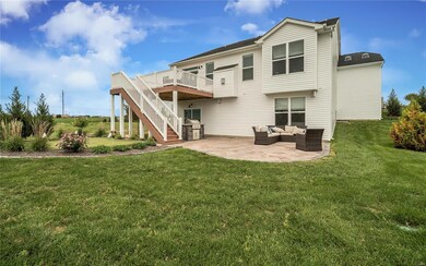 Rear elevation.  Maintenance free deck with stamped patio, bbq grill and putting green