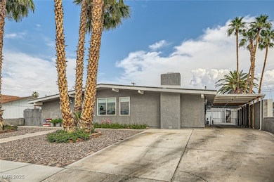 Mid-century home with stucco siding, driveway, a c