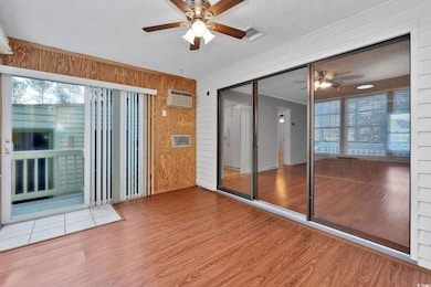 Interior space featuring wood walls, ceiling fan, 