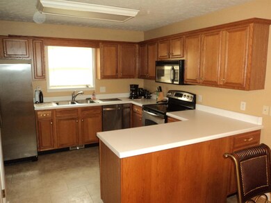 The kitchen has an abundance of Oak cabinetry and stainless appliances.
