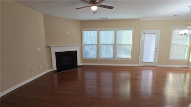 Unfurnished living room featuring wood finished fl